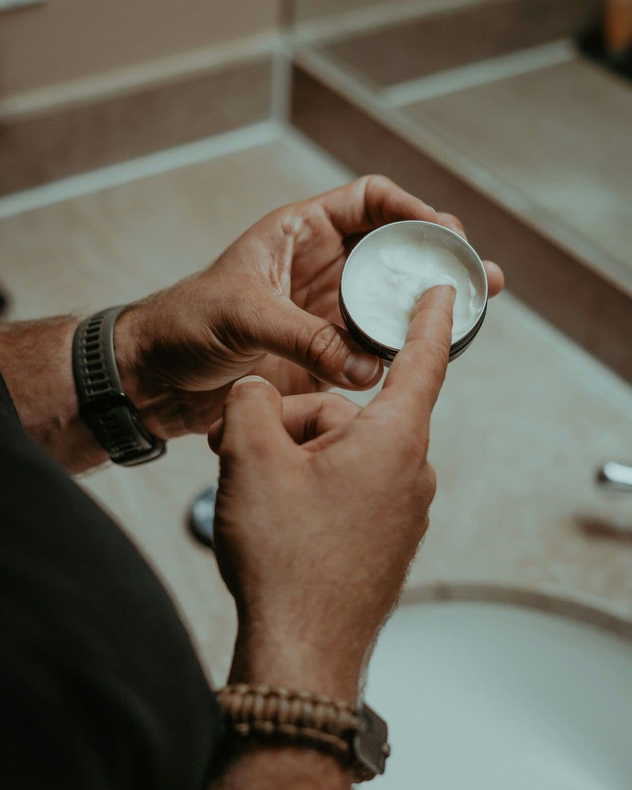 Man applying anti-perspirant body lotion for elite men's grooming routine in 2025.